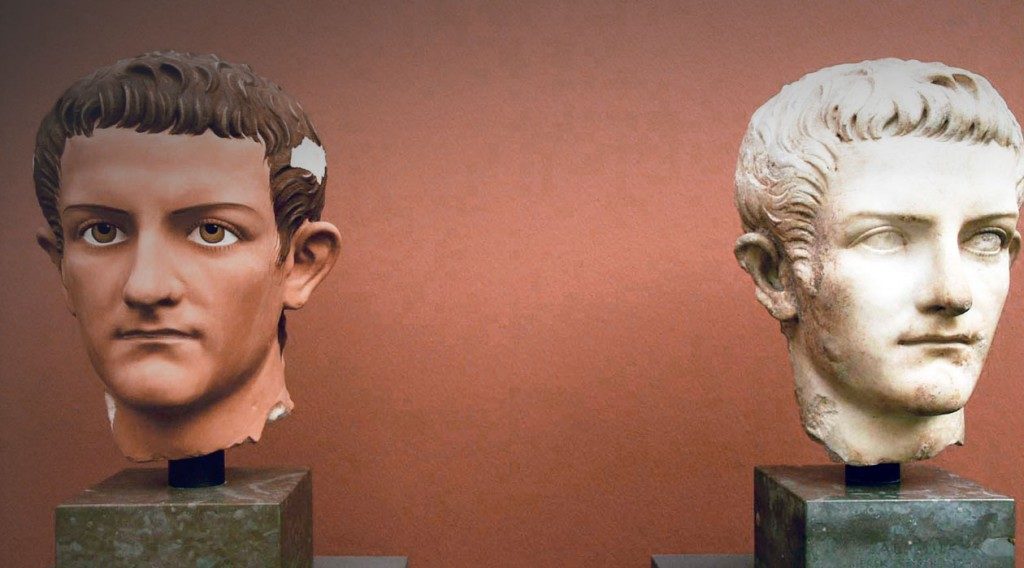 two sculptures, both busts the left is colored the white marble.
